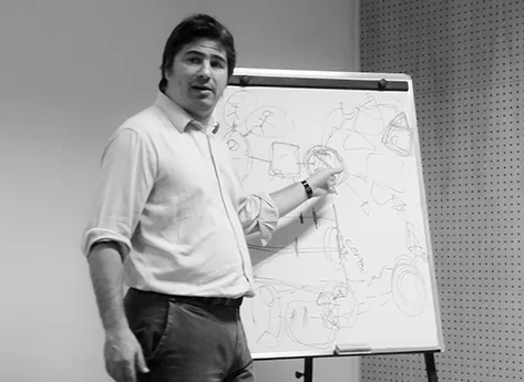 Roberto Durrieu dando clase frente a un rotafolio